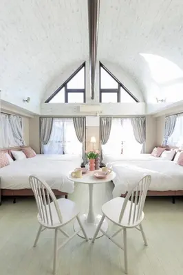 a bedroom with two beds and a table and chairs at UNITEDCUBE STAY TOKYO Private urban vacation home in Tokyo