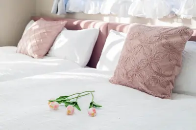 a pair of flowers on a bed with pillows at UNITEDCUBE STAY TOKYO Private urban vacation home in Tokyo