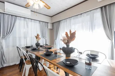 a dining room with a long table and chairs at UNITEDCUBE STAY TOKYO Private urban vacation home in Tokyo