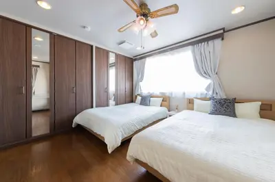 a bedroom with two beds and a ceiling fan at UNITEDCUBE STAY TOKYO Private urban vacation home in Tokyo