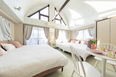 two beds in a room with a table and chairs at UNITEDCUBE STAY TOKYO Private urban vacation home in Tokyo