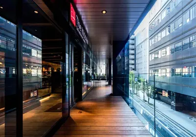 an empty hallway in a building with glass windows at Daiwa Roynet Hotel Ginza PREMIER in Tokyo