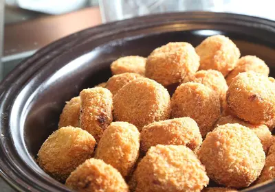 a bowl filled with doughnut holes in at Daiwa Roynet Hotel Ginza PREMIER in Tokyo