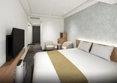 a hotel room with a bed and a television at Daiwa Roynet Hotel Ginza PREMIER in Tokyo