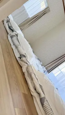 a bed sitting on top of a wooden floor next to a window at aiki house in Tokyo
