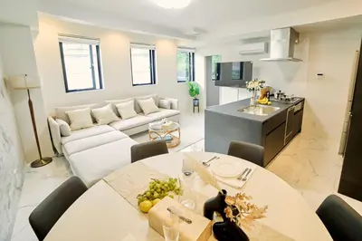 a kitchen and living room with a table and a couch at IoTele Minami-Aoyama in Tokyo