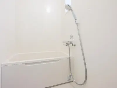 a shower in a bathroom with a white wall at ESTABLISHMENT Ueno in Tokyo