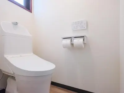 a bathroom with a toilet and two rolls of toilet paper at ESTABLISHMENT Ueno in Tokyo
