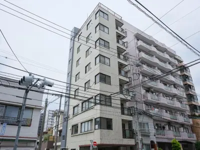 a tall white building with lots of windows at ESTABLISHMENT Ueno in Tokyo