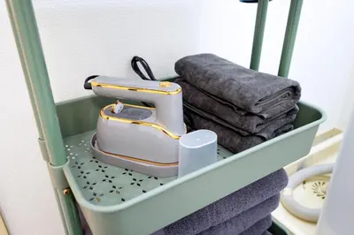 a shelf with a sewing machine and towels at Heisei Mansion - Vacation STAY 19183 in Tokyo