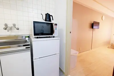 a kitchen with a tv on top of a refrigerator at Heisei Mansion - Vacation STAY 19183 in Tokyo