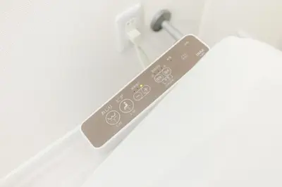 a remote control is attached to a light switch at Iriya House\u5165\u8c37\u516c\u5bd3702 in Tokyo