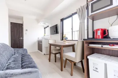 a living room with a couch and a table at Iriya House\u5165\u8c37\u516c\u5bd3702 in Tokyo