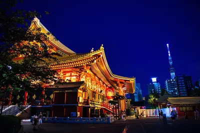 a lit up building with a tower in the background at Iriya House\u5165\u8c37\u516c\u5bd3702 in Tokyo