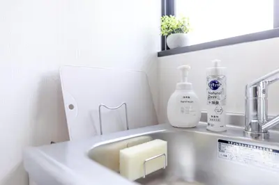 a bathroom sink with a soap dispenser next to it at Iriya House\u5165\u8c37\u516c\u5bd3702 in Tokyo