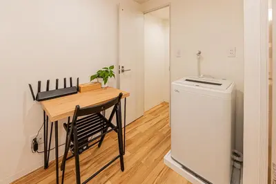 a small kitchen with a table and a small refrigerator at \u65c5\u5c4b \u8981\u753a\u516c\u5bd3,\u65e0\u7535\u68af in Tokyo