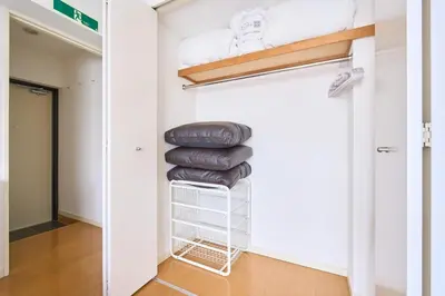 a room with a closet with a stack of pillows at 3B SHIBUYA Cozy Bright Apartment, 28sqm, free wifi, MAX 5PP in Tokyo