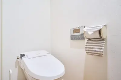 a white bathroom with a toilet and a towel at 3B SHIBUYA Cozy Bright Apartment, 28sqm, free wifi, MAX 5PP in Tokyo