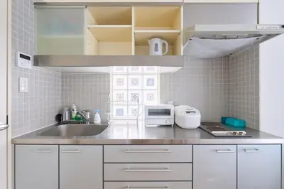 a kitchen with white cabinets and a sink at 3B SHIBUYA Cozy Bright Apartment, 28sqm, free wifi, MAX 5PP in Tokyo