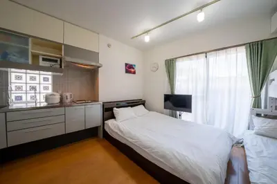 a small bedroom with a bed and a kitchen at 3B SHIBUYA Cozy Bright Apartment, 28sqm, free wifi, MAX 5PP in Tokyo