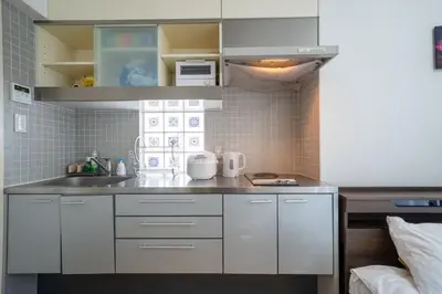 a small kitchen with white cabinets and a sink at 3B SHIBUYA Cozy Bright Apartment, 28sqm, free wifi, MAX 5PP in Tokyo