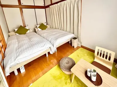 a small room with two beds and a table at Direct to Akihabara Shinjuku Max 6 people in Tokyo