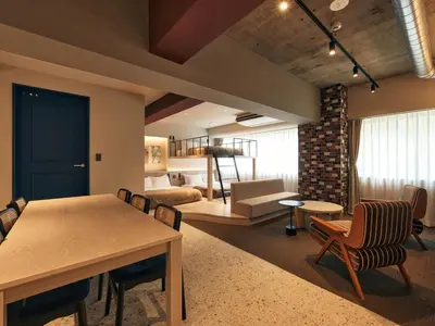 a room with a dining table and a living room at illi Pal Shinagawa Gotanda in Tokyo