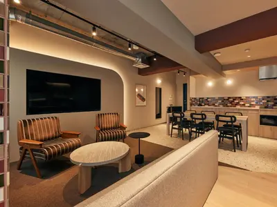 a waiting room with a couch and chairs and a table at illi Pal Shinagawa Gotanda in Tokyo