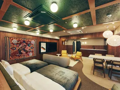 a living room with a bed and a dining room at illi Rug Hamamatsucho in Tokyo