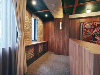 a room with wooden walls and a window and a counter at illi Rug Hamamatsucho in Tokyo