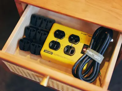 a yellow box with a charger and a black cable at illi Rug Hamamatsucho in Tokyo