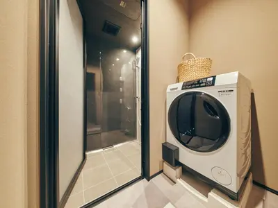 a washing machine with a basket on top of it at illi Tria Shibuya in Tokyo