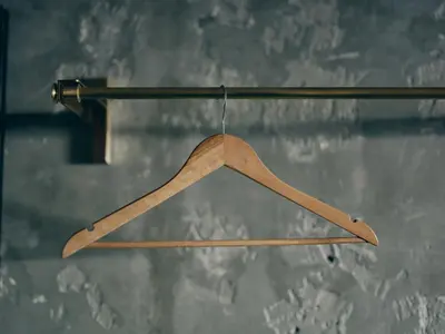 a wooden hanger hanging from a pole at illi Tria Shibuya in Tokyo