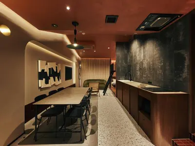 a kitchen with a long table and some chairs at illi Tria Shibuya in Tokyo