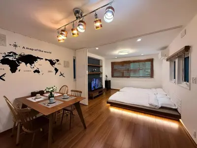 a bedroom with a bed and a table in a room at Sun inn \u4eac\u5cf6 in Tokyo