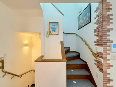 a staircase in a house with a brick wall at Sun inn \u4eac\u5cf6 in Tokyo