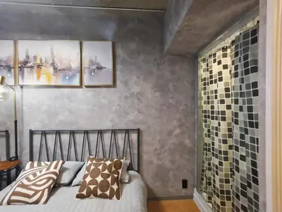 a bedroom with a bed and some pictures on the wall at PA Shinjuku St a-9mins -Higashishinjuku subway-5mins-\u65b0\u5bbf-\u6b65\u884c\u4f0a\u52bf\u4e398\u5206-MAX4p in Tokyo