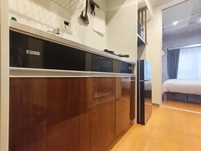a large entertainment center in a room with a bed at PA Shinjuku St a-9mins -Higashishinjuku subway-5mins-\u65b0\u5bbf-\u6b65\u884c\u4f0a\u52bf\u4e398\u5206-MAX4p in Tokyo