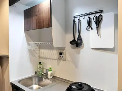 a kitchen with a sink and utensils on the wall at PA Shinjuku St a-9mins -Higashishinjuku subway-5mins-\u65b0\u5bbf-\u6b65\u884c\u4f0a\u52bf\u4e398\u5206-MAX4p in Tokyo
