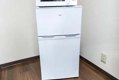 a white refrigerator with a microwave on top of it at 7th floor 702 with elevator, Minato area, 40 square meters, near Tokyo Tower, direct train to Haneda Airport, Narita Airport in Tokyo