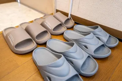 a row of pairs of shoes sitting on the floor at 7th floor 702 with elevator, Minato area, 40 square meters, near Tokyo Tower, direct train to Haneda Airport, Narita Airport in Tokyo