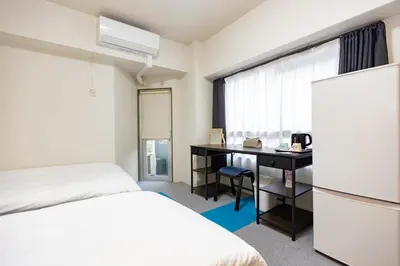 a hotel room with a bed and a desk and a window at ksi\u5357\u5e38\u76e4\u53f0301 in Tokyo