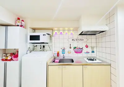 a small kitchen with a sink and a refrigerator at Jr\u5c71\u624b\u7dda\u6c60\u888b\u99c5\u5f92\u6b656\u5206\u5168\u65b0\u88c5\u4fee\u4e24\u5c45\u5ba4\u516c\u5bd3 in Tokyo