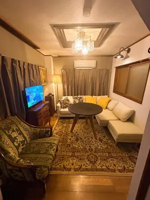 a living room with a couch and a table at Unique house mixed Japanese and European old style in Tokyo