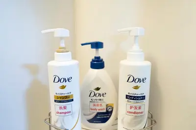 three bottles of deodorants are sitting in a rack at 7th floor 701 with elevator 40 square meters in the port area, close to Tokyo Tower, direct access to Haneda Airport in Tokyo