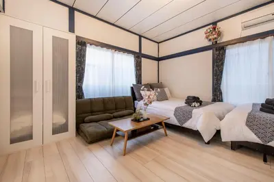 a bedroom with a bed and a couch at Central Panda Hotel in Tokyo