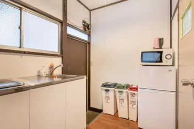 a kitchen with a refrigerator and a microwave at Central Panda Hotel in Tokyo