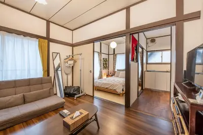 a living room with a couch and a bed at Central Panda Hotel in Tokyo