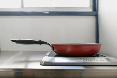 a frying pan sitting on top of a stove at Central Panda Hotel in Tokyo