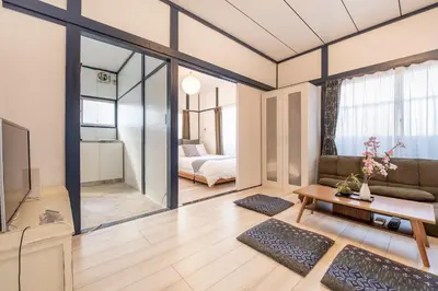 a living room with a couch and a tv at Central Panda Hotel in Tokyo